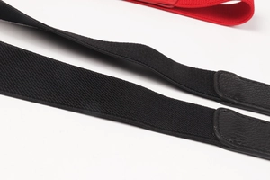 Detail of black elastic cinch belt with leather attachment and leaf buckle mechanism