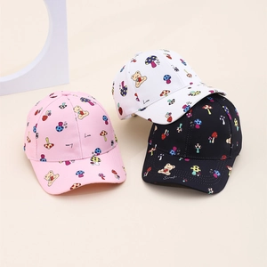 Detailed view of colorful cartoon mushroom and bear prints on kids baseball caps