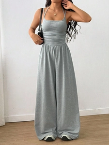 Detail of grey knitted wide-leg jumpsuit with high-waist design and soft fabric texture