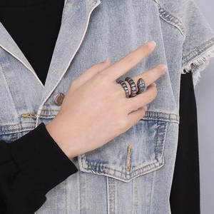 Vintage stainless steel snake ring with realistic scale texture worn on woman's finger