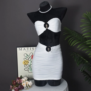 Detail of white pleated texture two-piece set featuring a central circular metal ring buckle