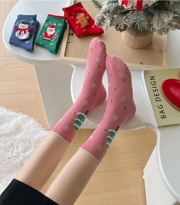 Detailed view of colorful cartoon Christmas socks featuring festive holiday patterns