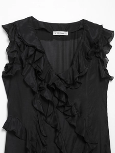 Close-up detail of black sleeveless V-neck dress with ruffles and size label information
