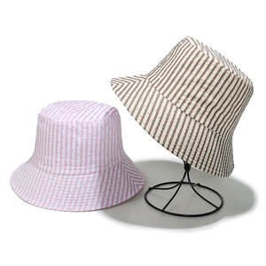 Striped cotton sun hat with subtle sparkles shown on a stand in pink and brown