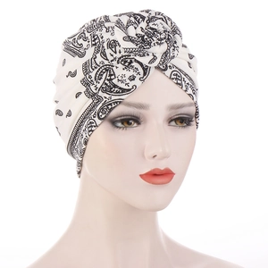 Detail of bohemian paisley print turban with a stylish knot on a white mannequin