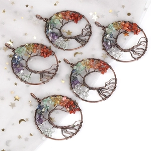Detail view of five handmade tree of life pendants with colorful natural stones and wire wrap
