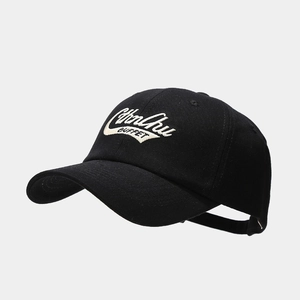 Detail of embroidered lettering on black cotton baseball cap with vintage street style
