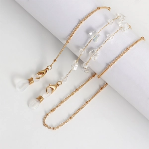 Detail of gold metal eyeglass chain with transparent butterfly beads and lobster clasps