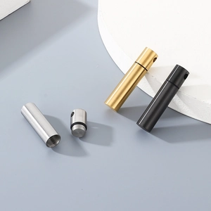 Detail of waterproof stainless steel capsule pendants with rubber seals in gold, black and silver