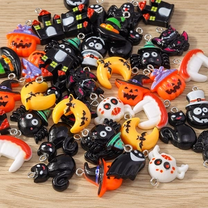 Mix of Halloween charms featuring pumpkin, ghost, and bat shapes for DIY jewelry making