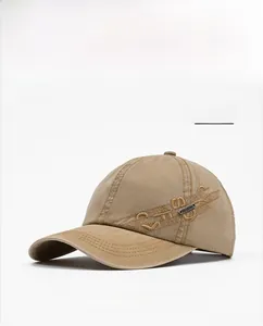 Detailed embroidery and CD logo on light tan washed cotton baseball cap side view