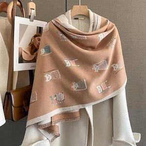 Close-up of brown cashmere scarf featuring cute cartoon cats and fringe tassel details