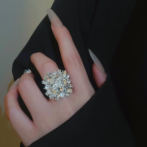 Macro detail of silver flower cluster ring with sparkling marquise cut crystals