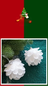 Detail of white petal-shaped Christmas foam ball ornaments with glitter on tree