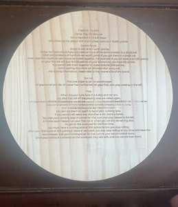 Vertical view of a wooden Farkle game rules board with clear printing and light wood grain