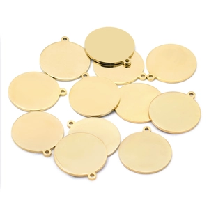 Macro detail of polished gold-plated round stainless steel DIY charm tags for jewelry