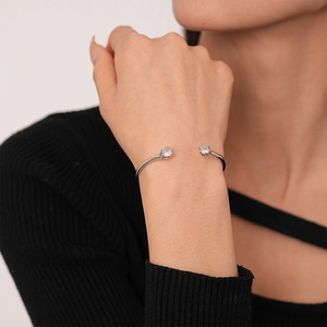 Minimalist silver geometric open cuff bracelet with sparkling zircon flowers on wrist
