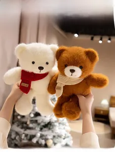 Close-up of plush teddy bears in white and brown wearing cozy knit smile scarves