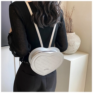 Rear view of a white heart-shaped backpack with Rich Rabbit pattern and metallic finish