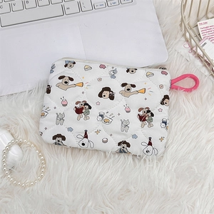Close-up of white quilted cosmetic bag featuring cute cartoon dog prints and a pink ring hook