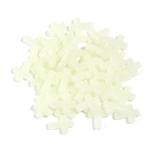 Detailed view of luminous plastic cross beads for DIY jewelry and necklace making