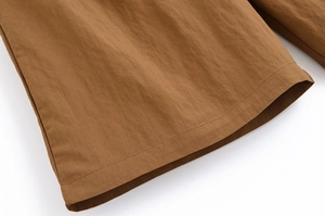 Macro shot of fine stitching on brown twill fabric for premium suit set texture