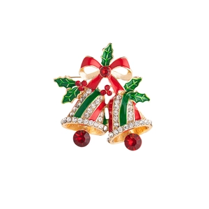 Detailed view of Christmas bell brooch with red bow and green holly enamel