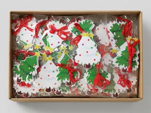 Bulk pack of green and white Christmas tree shaped paper hanging decorations in a box