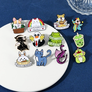 Detailed close-up of colorful enamel animal pins including corgis and ducks on a white tray