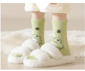 Detail of green frog embroidery socks and white plush cross-strap slippers for home