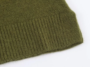 Close-up of ribbed cuffs on dark green short-sleeved knitwear with plush texture
