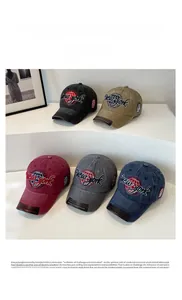 Detail view of New York embroidered washed cotton baseball caps in multiple colors