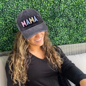 Detail of mama chenille embroidery on dark grey washed denim baseball cap with ponytail hole