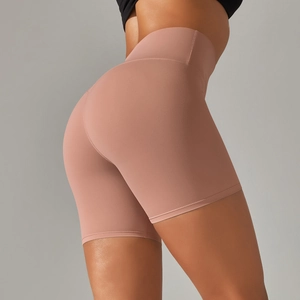 Close-up of high-waisted yoga shorts in dusty rose fabric with peach-lift stitching