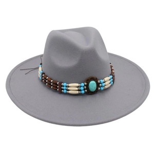 Detailed shot of bohemian turquoise beaded band on a grey wool wide brim fedora hat