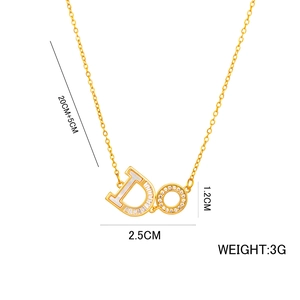 Gold letter D necklace with mother of pearl and zircon stones on a white background