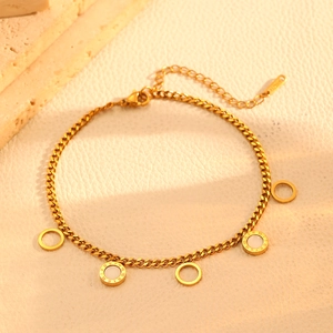 Detail of a gold stainless steel bracelet featuring shell inlays and Roman numerals