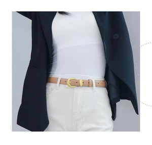 Close-up of khaki leather belt with golden C-shape buckle on blue blazer and white pants