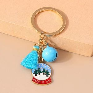 Detail of Christmas keychain with blue tassel, bell, and Merry Christmas crystal ball