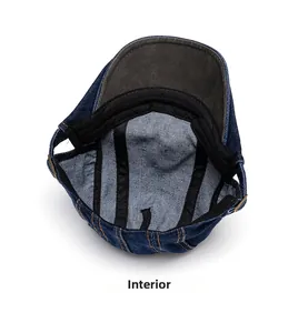 Internal view of dark blue denim newsboy cap showing sweatband and stitching details