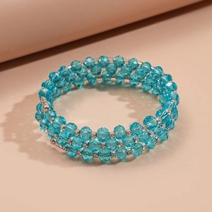 Detailed close-up of triple-layered blue crystal beads with sparkling silver spacers