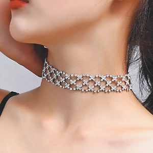 Close-up of silver mesh choker with rhinestones and heart pendant on a model's neck