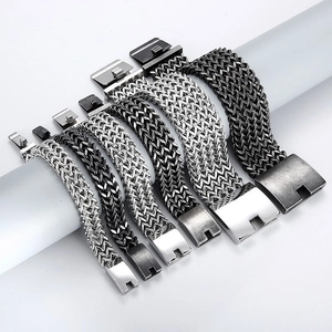 Detail of masculine braided stainless steel bracelets in silver and black on display