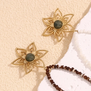 Detail of 18K gold plated flower pendant with green stone and tassel beads