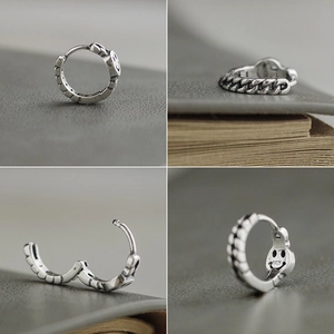 Detail view of S925 sterling silver earring featuring retro chain texture and smile face