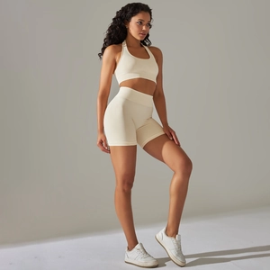 Seamless high-waisted beige yoga set with halter sports bra and compression shorts