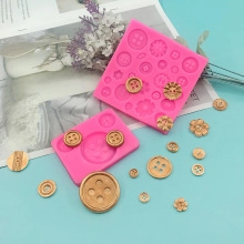 Flat lay of pink silicone button molds for DIY baking and handmade soap crafts