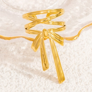 Polished gold stainless steel ring with layered cross-line bow design and long tassels