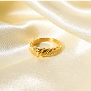 Detail of 18k gold plated croissant ring with spiral texture on champagne silk