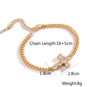 Detailed view of gold plated cross bracelet with zircon crystals and lobster clasp